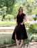 CONJUNTO DE SAIA COM BOLSOS E BLUSA COM BOTÕES NO OMBRO - Preto